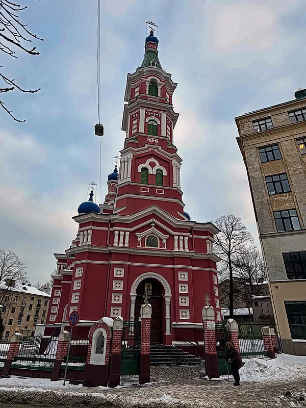 A red Orthodox church in the snow